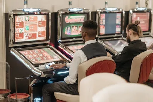 two person operating slot machines 
